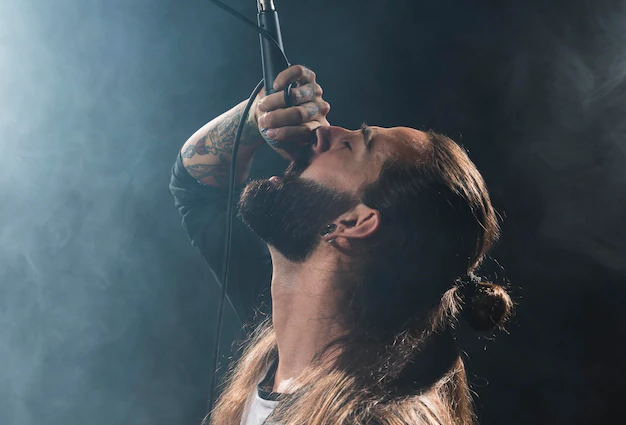 A rapper with a microphone, passionately performing on stage