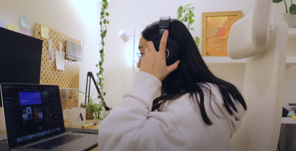 Photo of a girl wearing a headset and sitting in front of a laptop