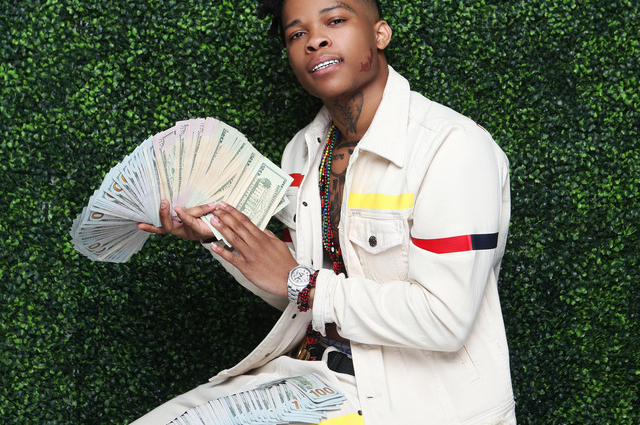 Rapper YNW Bortlen holding money