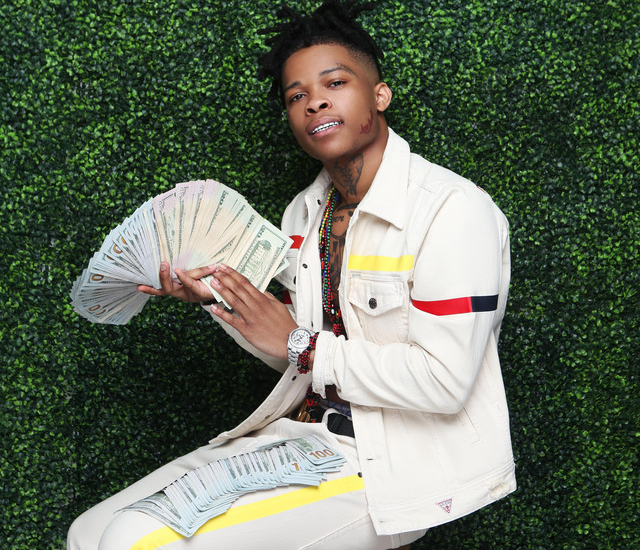 Rapper YNW Bortlen holding money