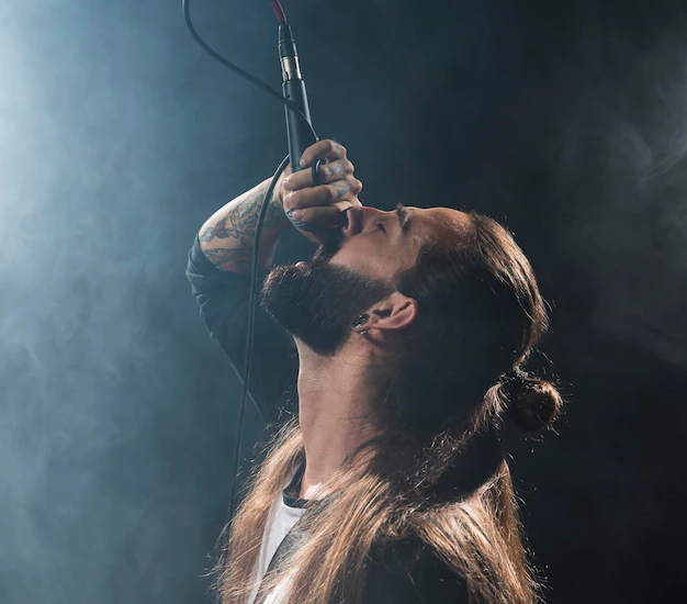 A rapper with a microphone, passionately performing on stage